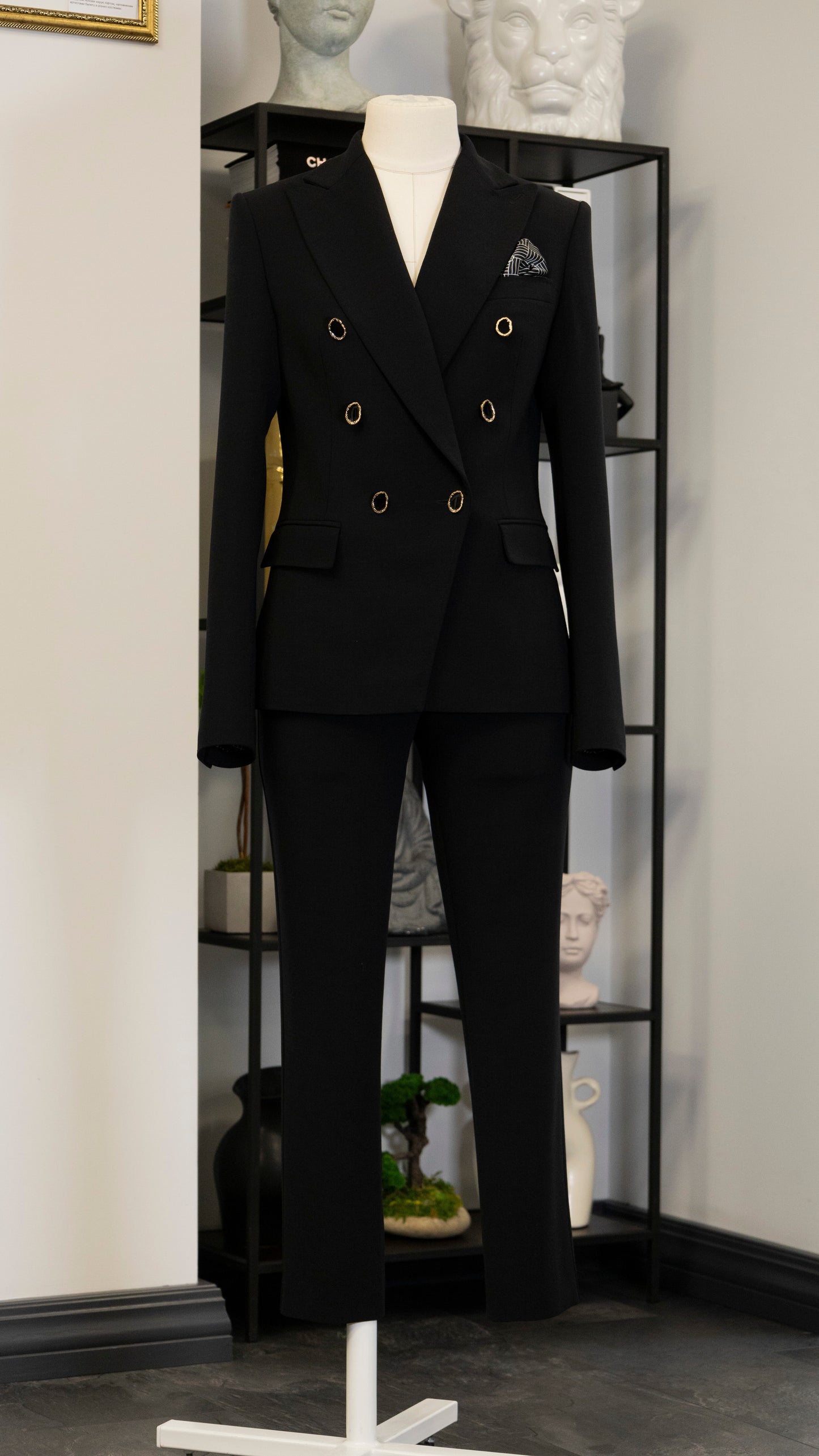 Black four-piece suit made of wool with a silk lining.