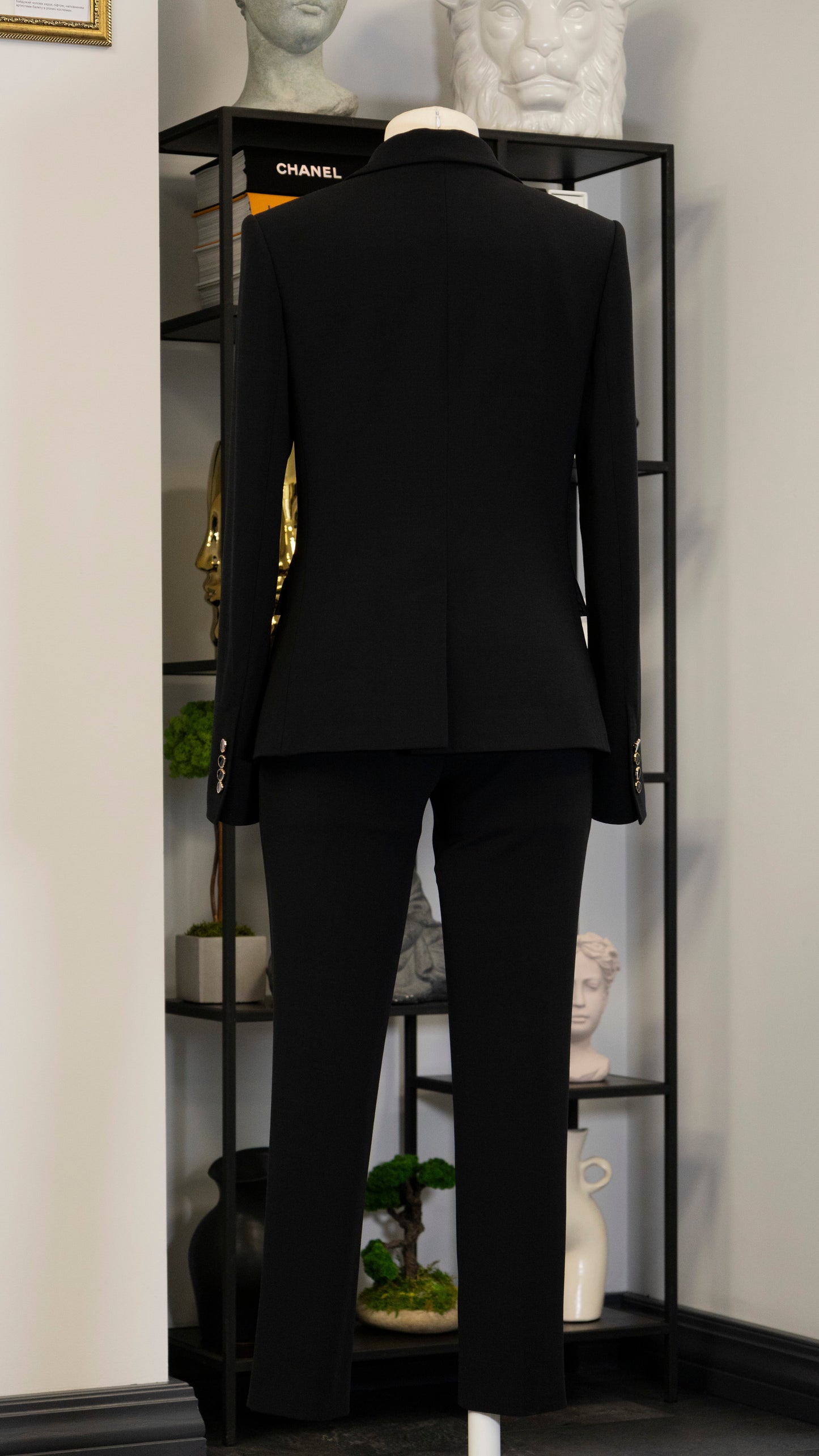 Black four-piece suit made of wool with a silk lining.