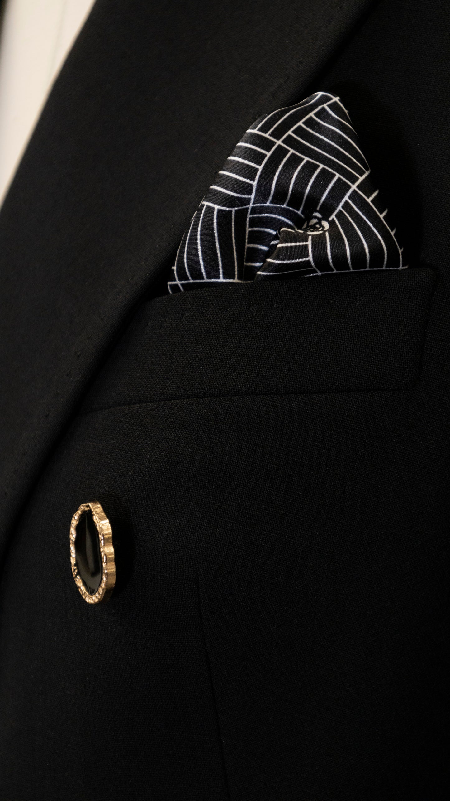 Black four-piece suit made of wool with a silk lining.