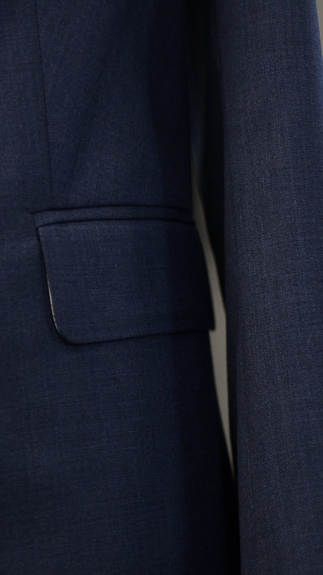 Blue four-piece suit made of wool with a silk lining.