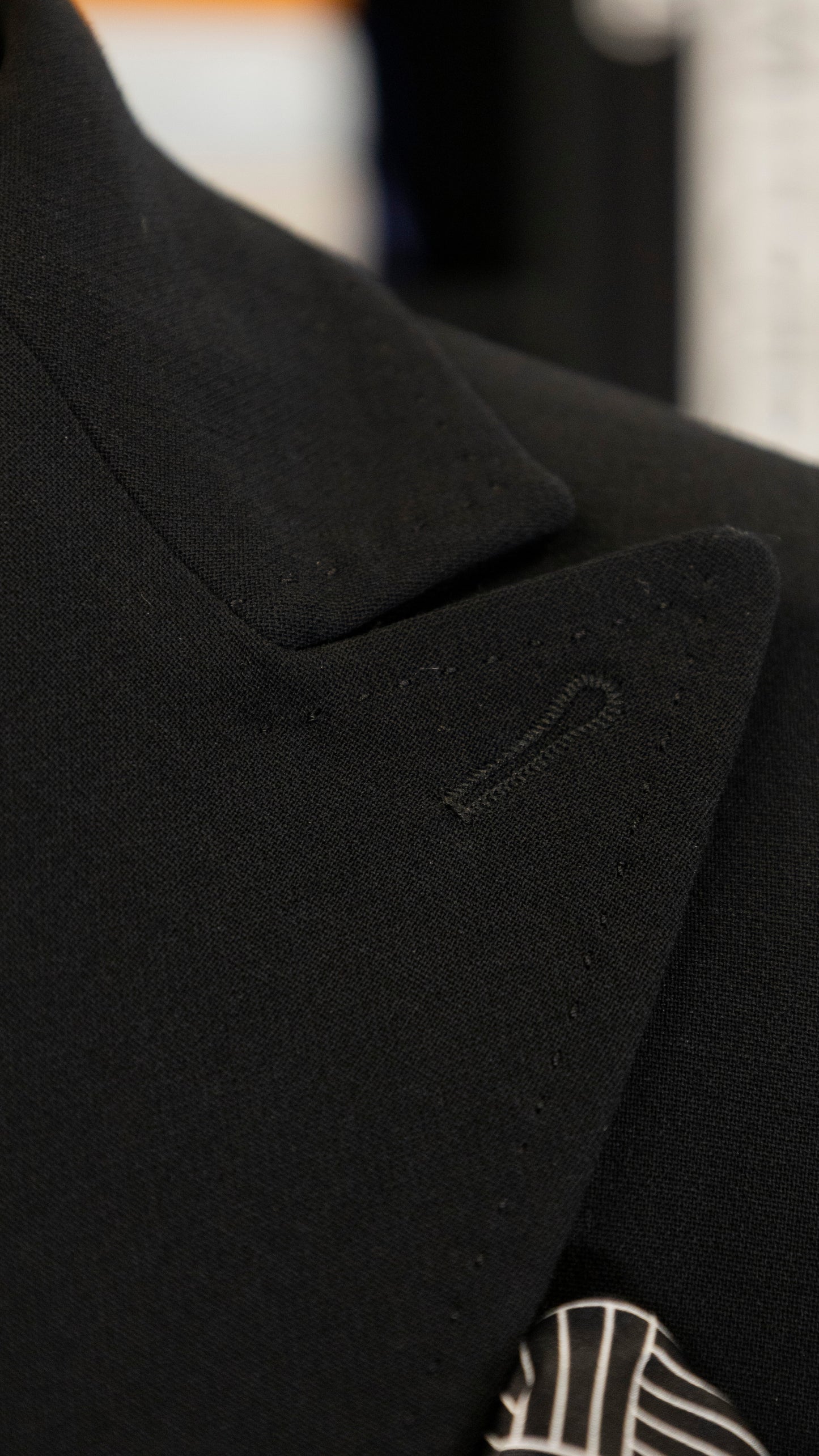 Black four-piece suit made of wool with a silk lining.