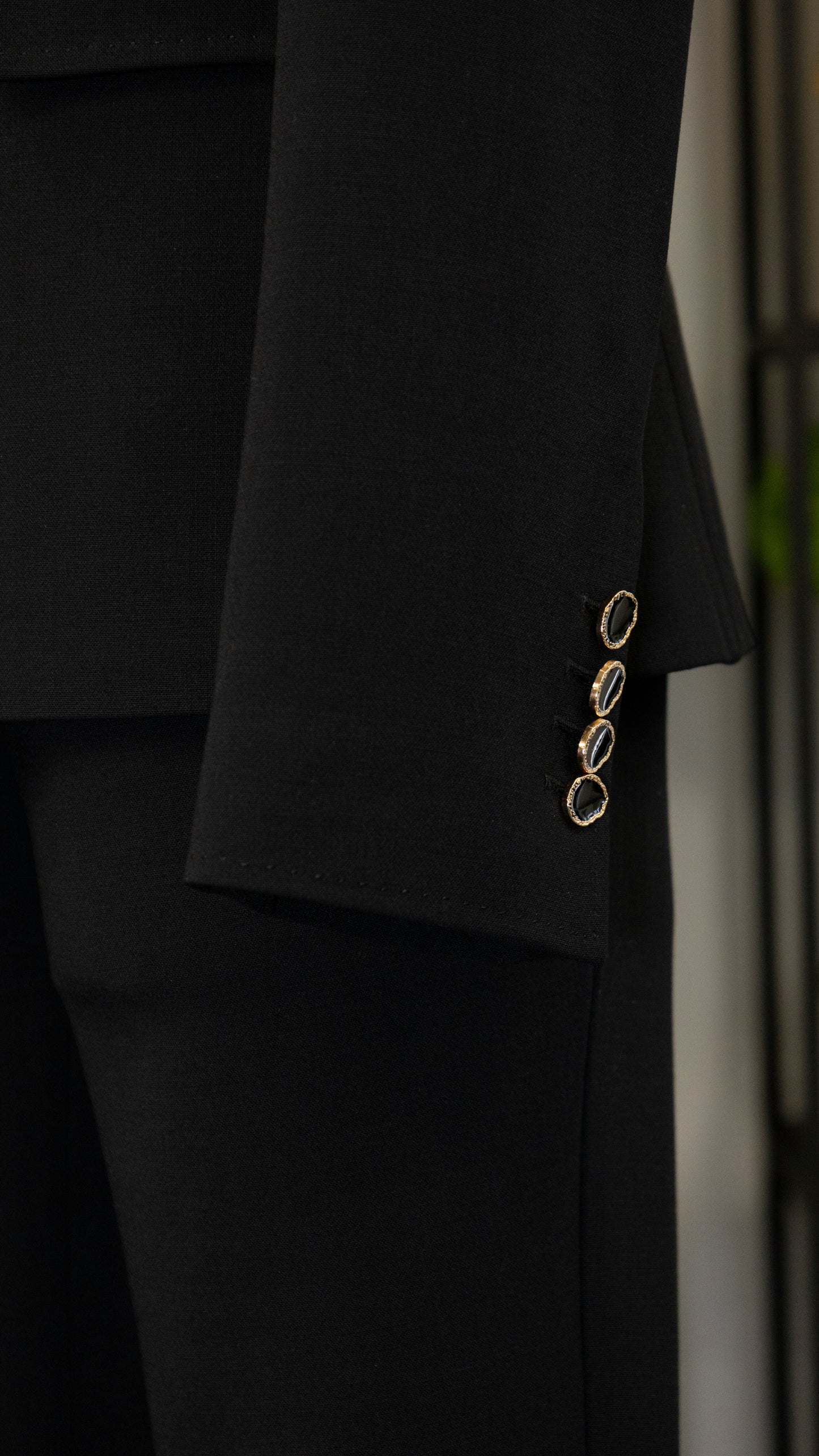 Black four-piece suit made of wool with a silk lining.